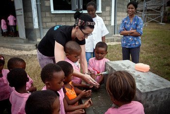 Katy Perry shows children how to wash their hands properly, during a visit a pre-school in the village of Sahavola in Analanjirofo Region, Madagascar.