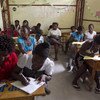 Women learn to read and write in a classroom in Cité Soleil, Haiti.