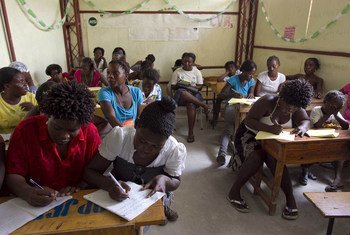 Women learn to read and write in a classroom in Cité Soleil, Haiti.