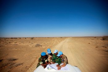 Peacekeepers with the UN Mission for the Referendum in Western Sahara (MINURSO) consult a map as they drive through vast desert areas in Smara, Western Sahara.