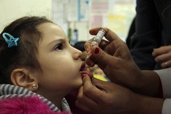 A girl receives a dose of oral polio vaccine at a health centre in Damascus, Syria.