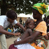 A nurse gives a measles vaccination to a child in Guinea-Bissau.