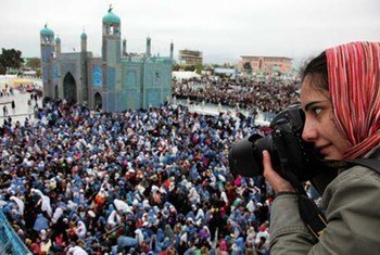Photographer Farzana Wahidy covering a women's empowerment event in Mazar-i-Sharif, in Afghanistan's north.