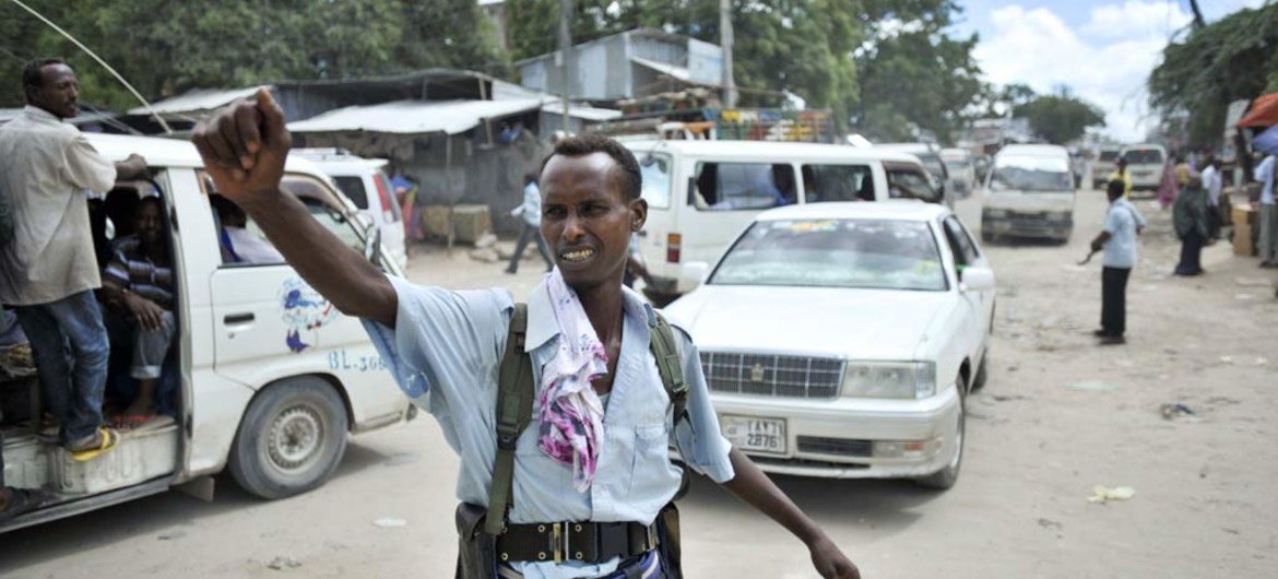 A policeman directs traffic at a checkpoint in downtown Mogadishu, Somalia.
