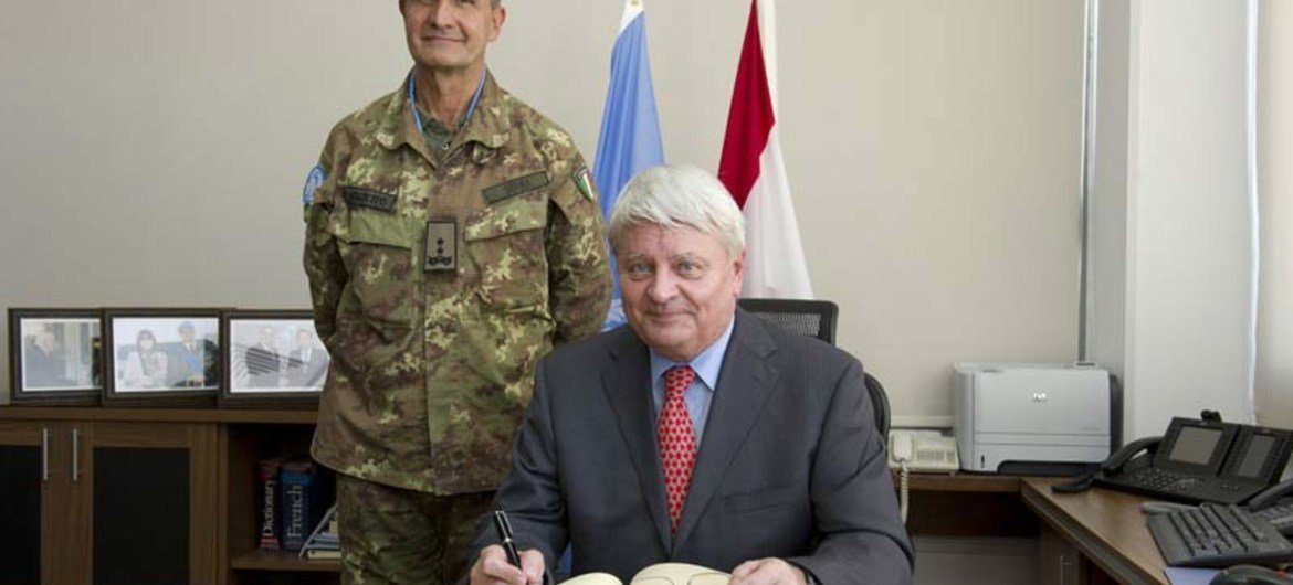 Under-Secretary-General for Peacekeeping Operations Herve Ladsous signs the honour book at UNIFIL HQ in the presence of Force Commander Major-General Paolo Serra.