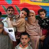 Following time in Pakistan, an Afghan returnee family awaits assistance from the Office of the UN High Commissioner for Refugees (UNHCR) in Kabul.