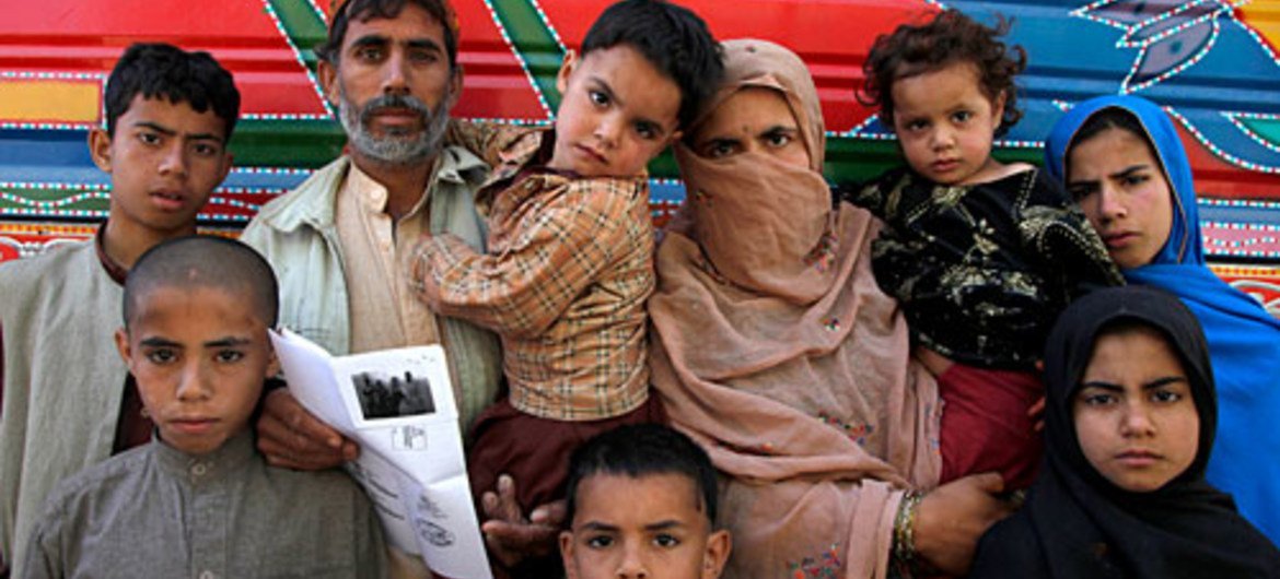Following time in Pakistan, an Afghan returnee family awaits assistance from the Office of the UN High Commissioner for Refugees (UNHCR) in Kabul.