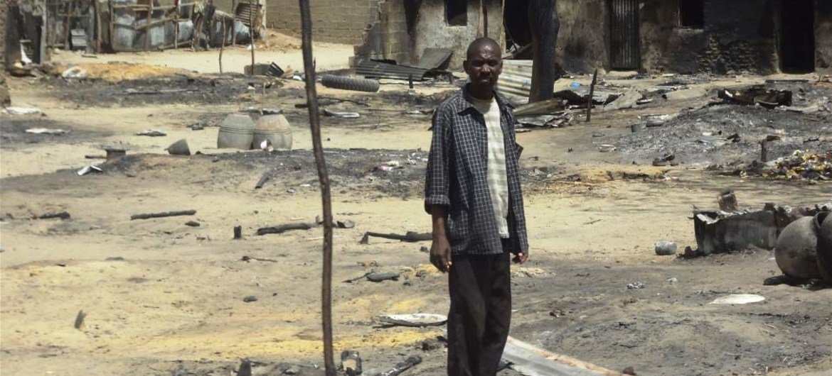 A man stands outside his destroyed home in Baga, Borno State, Nigeria, following heavy fighting between military forces from Nigeria, Niger and Chad, and Boko Haram.