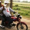 Red Crescent volunteers use a megaphone to issue cyclone warnings to residents of Sonagazi, Bangladesh.