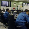 Workers monitor the Fukushima Daiichi Nuclear Power Plant from the Emergency Response Centre.
