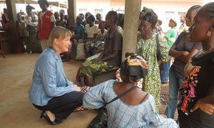 Humanitarian Coordinator for the Central African Republic, Kaarina Immonen (left), talks to people waiting to receive food assistance at the community hospital in Bangui.