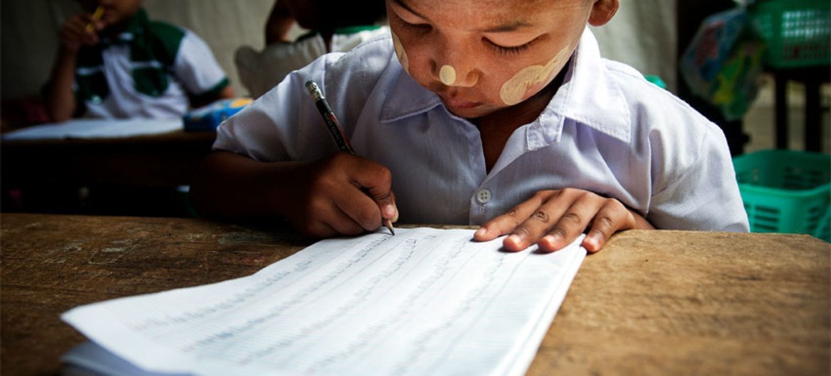 A child practices his writing during a kindergarten class.