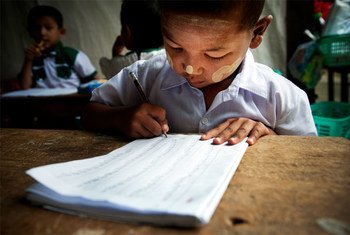 A child practices his writing during a kindergarten class.