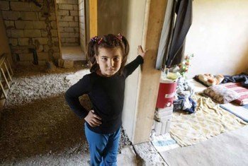 An eight-year-old Syrian refugee girl stands outside her room in the home of her Lebanese hosts in the Bekaa Valley.