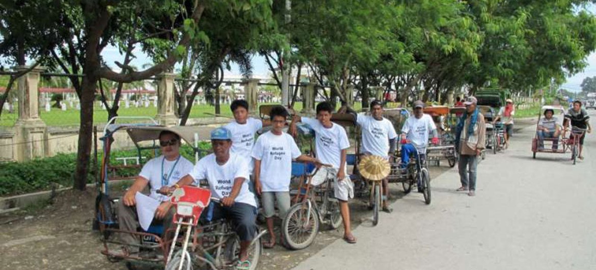 Pedicab drivers in Mindanao, the Philippines, support World Refugee Day. Many of them are internally displaced.