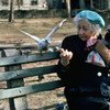 An elderly person feeds pigeons in New York City's Central Park.