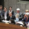 Secretary-General Ban Ki-moon (centre) addresses the Security Council. At right is United States Secretary of State John Kerry.