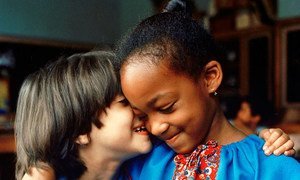 Two children in a Bronx, New York, school solidifying their friendship with a spontaneous expression of mutual understanding.