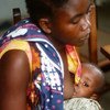 A mother breastfeeds her child in Tanzania.