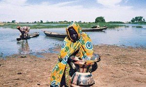 A villager takes extra precautions to keep her supply of water clean in Niger.