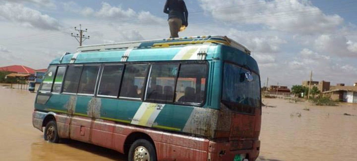 A man stands on a bus in the Sharg al Nil area of Khartoum, Sudan, where as many as 530,000 people may have been affected since the start of August 2013.
