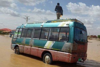 A man stands on a bus in the Sharg al Nil area of Khartoum, Sudan, where as many as 530,000 people may have been affected since the start of August 2013.