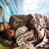 With support from a Global Fund grant, a woman and a child sleep under an insecticide-treated net in Atsapanethong District, Laos.
