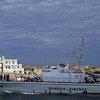 A customs boat enters a port in southern Italy after searching for boats carrying people hoping to reach Europe. More and more Syrians are taking sea routes to the continent.