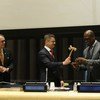 Outgoing General Assembly President Vuk Jeremic (centre) hands over gavel to incoming President John Ashe of Antigua and Barbuda. Deputy Secretary-General Jan Eliasson is at left.