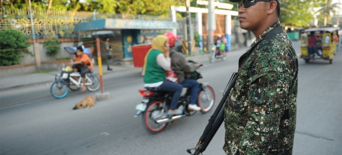 Un membre des Forces armées des Philippines à un point de contrôle dans les rues de Cotabato.