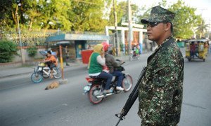 A member of the Armed Forces of the Philippines (AFP) at a checkpoint on the streets of Cotabato.