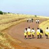 School children in uniform walk long distances to and from school in the rural Kwa Zulu Natal, South Africa.