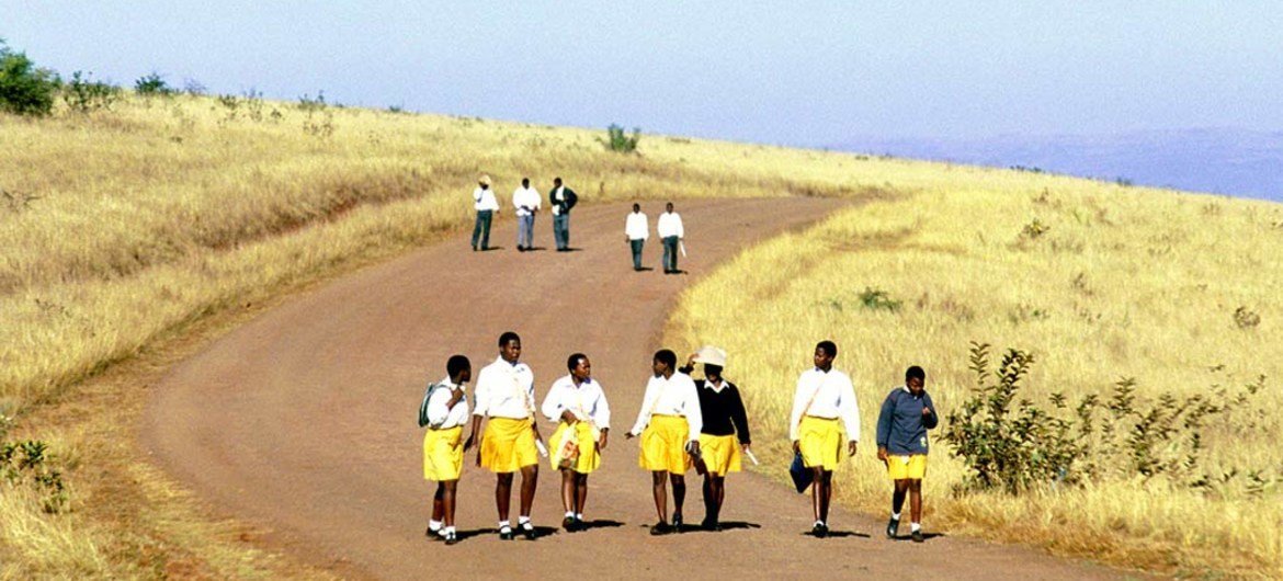 School children in uniform walk long distances to and from school in the rural Kwa Zulu Natal, South Africa.