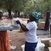 A displaced woman receives aid items from UNHCR in Uganga, Central African Republic.