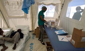 A nurse prepares re-hydration fluid for patients at a Cholera treatment center in Lester, a town 2 hours north of Port au Prince, Haiti. (2012)