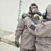 During an OPCW training course on emergency response to chemical incidents, participants learn to use protective gear.