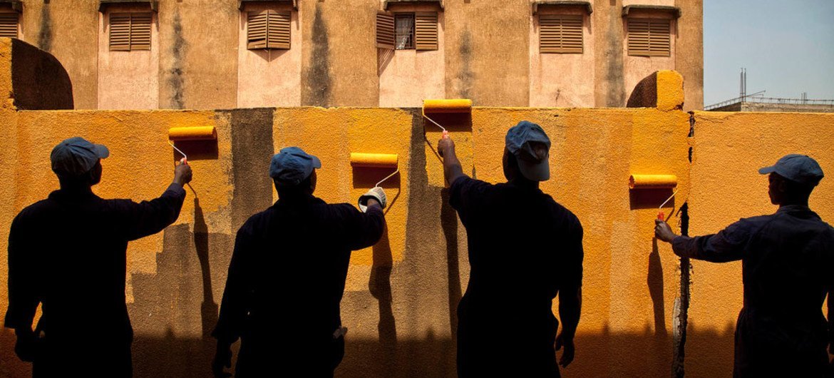 UN peacekeepers from Ghana Engineering Contingent paint the wall of a public school in Taliko, Bamako, Mali. Photo MINUSMA/Marco Dormino