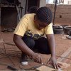 Piassa helps at her father’s workshop, in Nampula, Mozambique after receiving entrepreneurship training under the UNIDO ECP Programme.
