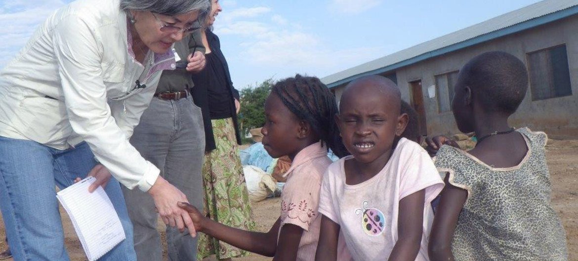 Deputy Emergency Relief Coordinator Kyung-wha Kang with children at a Juba way station in Jonglei state, South Sudan.