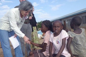 Deputy Emergency Relief Coordinator Kyung-wha Kang with children at a Juba way station in Jonglei state, South Sudan.