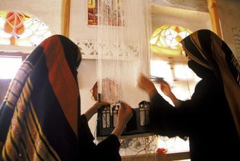 Young Yemeni women at work weaving a rug. Bani Hushaish, Yemen.