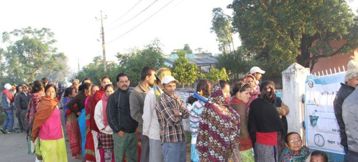 Nepalese wait at a polling centre to vote in the 19 November 2013 elections for members of the Constituent Assembly.