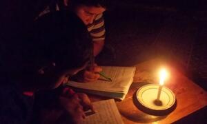 Children read by candle light due to limited hours of electricity in the Gaza Strip. 