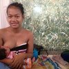 Jhana breastfeeds her daughter Gwendolyn in Tacloban.