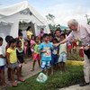 UNICEF Executive Director Anthony Lake greeting children in Guiuan, Philippines, during a four-day visit to areas devastated by Typhoon Haiyan.