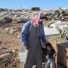 Father and son standing with their belongings following the latest demolitions in the West Bank, which displaced 68 people.