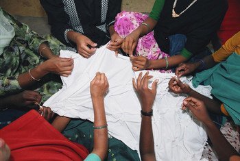 Hands of women in the garment industry.