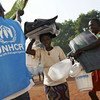 A displaced woman and her son carry aid from a UN distribution point in Bossangoa.