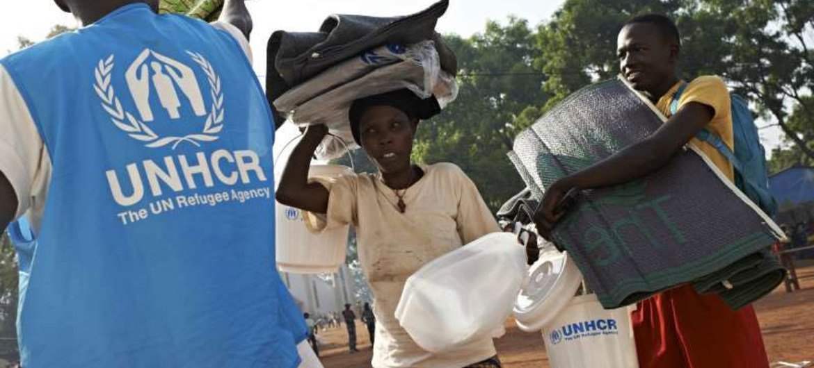 A displaced woman and her son carry aid from a UN distribution point in Bossangoa.