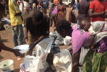 Displaced civilians collect food rations at a WFP distribution site near Bangui airport.